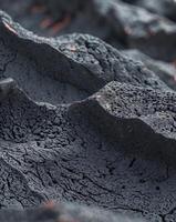 Lava rock texture featuring a porous black volcanic surface with sharp edges photo