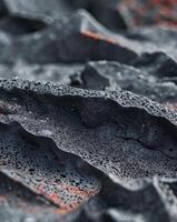 Lava rock texture featuring a porous black volcanic surface with sharp edgesLava rock texture featuring a porous black volcanic surface with sharp edges. photo