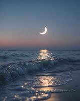 Glowing waves illuminate the shore under a crescent moon at twilight photo