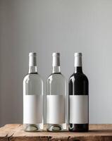 three bottles of wine with a blank label on a wooden table photo