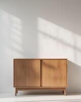 A wooden cabinet with a white wall above it photo