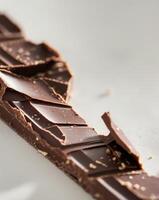 Broken chocolate bar texture background - photo