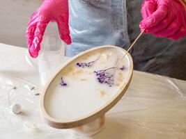 art process of pouring epoxy resin into a wooden toy photo