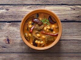 meat with bulgur and chickpeas in red sauce with dates and raisins. photo