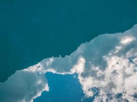 Sky in the water background. Abstract turquoise natural background with a reflection of the white sky in the water. photo