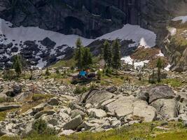 Camp is in the distance under a high cliff photo