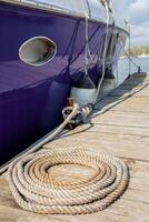 The rope is twisted in a circle lying on the pier. photo