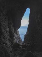 Narrow hole in the cave, an exit from the dungeon photo