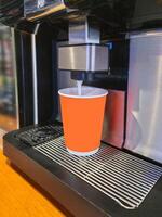 Process of making latte coffee in a coffee machine. photo