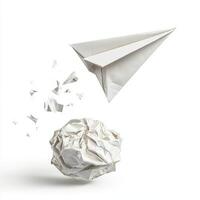 Crumpled paper ball and paper airplane in a playful moment of creativity and imagination photo