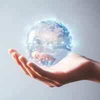 Hand holding a glowing digital globe representing global connectivity and technology photo