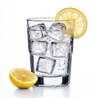 Refreshing lemon drink with ice cubes served in a clear glass on a bright background photo