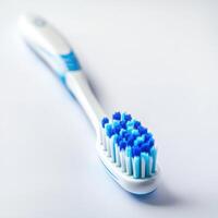 Toothbrush on white background demonstrating dental hygiene essentials at home photo