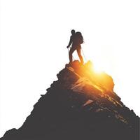 Climber reaching the summit as the sun rises over the mountain peak at dawn photo