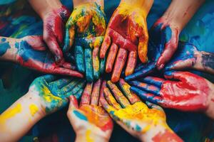 Hands covered in colorful paint create a vibrant display of creativity and collaboration during an outdoor art session photo