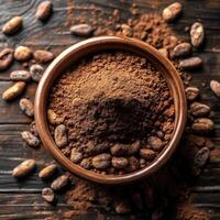Rich cocoa powder and cocoa beans in a wooden bowl on rustic wooden surface photo