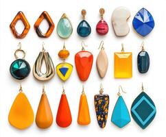 Colorful collection of handmade earrings in various shapes and styles displayed on a white background photo