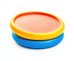 Colorful flying discs stacked on top of each other against a white background for outdoor recreation options photo