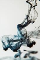Macro photography of a drop of ink dispersing in water creating fluid shapes and abstract forms with intricate swirls and patterns - Variant 31 photo