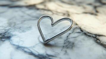 a Solitary paperclip bent into a heart shape resting on white marble soft shadows and modern minimalist concept photo