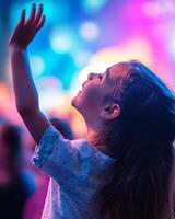 Back view of a child cheering enthusiastically at a vibrant event with rainbow-colored lighting and energetic atmosphere raised hand photo