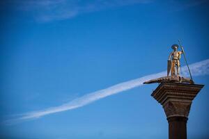 A statue of a man on top of a pillar photo