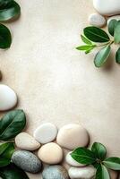 The arrangement showcases smooth white and beige pebbles along with green leaves on a soft beige surface, illuminated by natural light, providing a calming and earthy feel for various purposes photo