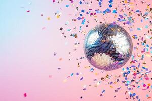 A shiny silver disco ball reflects light as colorful confetti floats around it, creating a joyful and celebratory mood against a soft pastel gradient backdrop perfect for events photo