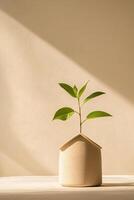 A small green plant emerges from a house-shaped pot, representing growth in real estate investment. Set against a calming beige backdrop, this composition inspires tranquility and potential photo