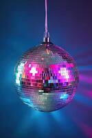 A shiny silver disco ball hangs in the center, reflecting colorful light beams in pink, purple, and blue hues against a dark gradient background. Perfect for capturing a lively atmosphere photo