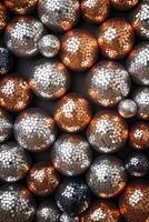 Abstract design showcases a pattern of disco ball shapes in metallic silver, gold, and rose gold against a dark background, offering spacious areas for text overlay and modern aesthetics photo
