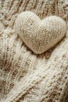 This cozy Valentine's background features a soft, knitted texture in light beige tones and a small heart accent, providing large negative space for personalized text overlays photo