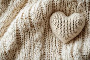 Soft knitted texture in light beige creates a warm, inviting backdrop for Valentine's Day. A small heart accent adds a charming touch to the large negative space, perfect for text overlay photo