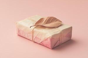 This handcrafted gift box is made from recycled paper, beautifully adorned with dried autumn leaves. It is set against a soft pastel background, creating a natural, eco-friendly appeal photo