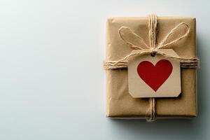 Handcrafted gift box wrapped in eco-friendly recycled paper, elegantly tied with cotton string and featuring a personalized tag with a heart design, set against a clean, light surface photo