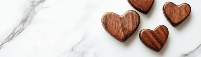 Small wooden hearts are arranged on a smooth white marble surface illuminated by soft natural light, creating a minimalist and stylish theme perfect for Valentine's Day messages photo