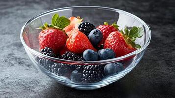 A Colorful Mix of Fresh Berries in a Glass Bowl photo