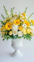 Graceful floral composition of yellow and white blooms in a sophisticated vase photo