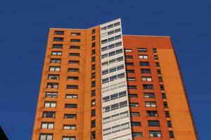A tall building with a clock on it in rotterdam holland photo
