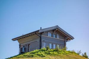 A small house sitting on top of a hill photo