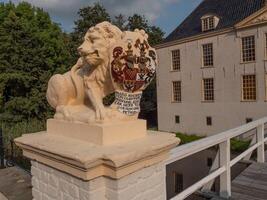 A statue of a lion on a bridge at dornum castle photo