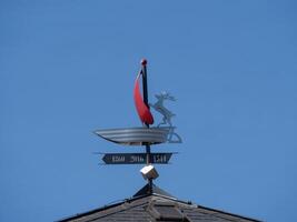 A weather vane on top of a building photo