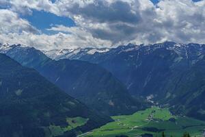 A view of a valley with a mountain range in the background photo