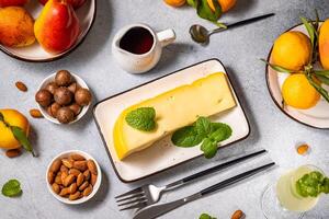 Gourmet cheese platter with fruits, nuts, and wine on table setting photo