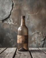 Old brown glass bottle is standing on a wooden surface with a grunge wall backgroundOld brown glass bottle is standing on a wooden surface with a grunge wall background. photo