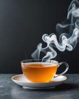 Orange tea in a cup and a black background with white smoke behind it photo