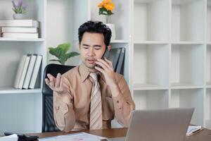 Businessman negotiating on a phone call in a contemporary office, demonstrating effective communication skills photo