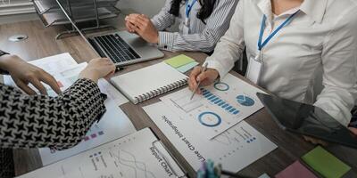 Business team analyzing charts and data reports in a collaborative workspace photo