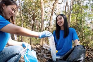 Volunteers collecting garbage in a forest, promoting environmental awareness and community service photo