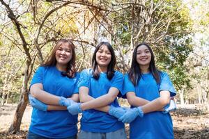 Three young volunteers participating in a community cleanup, showcasing teamwork and environmental stewardship photo